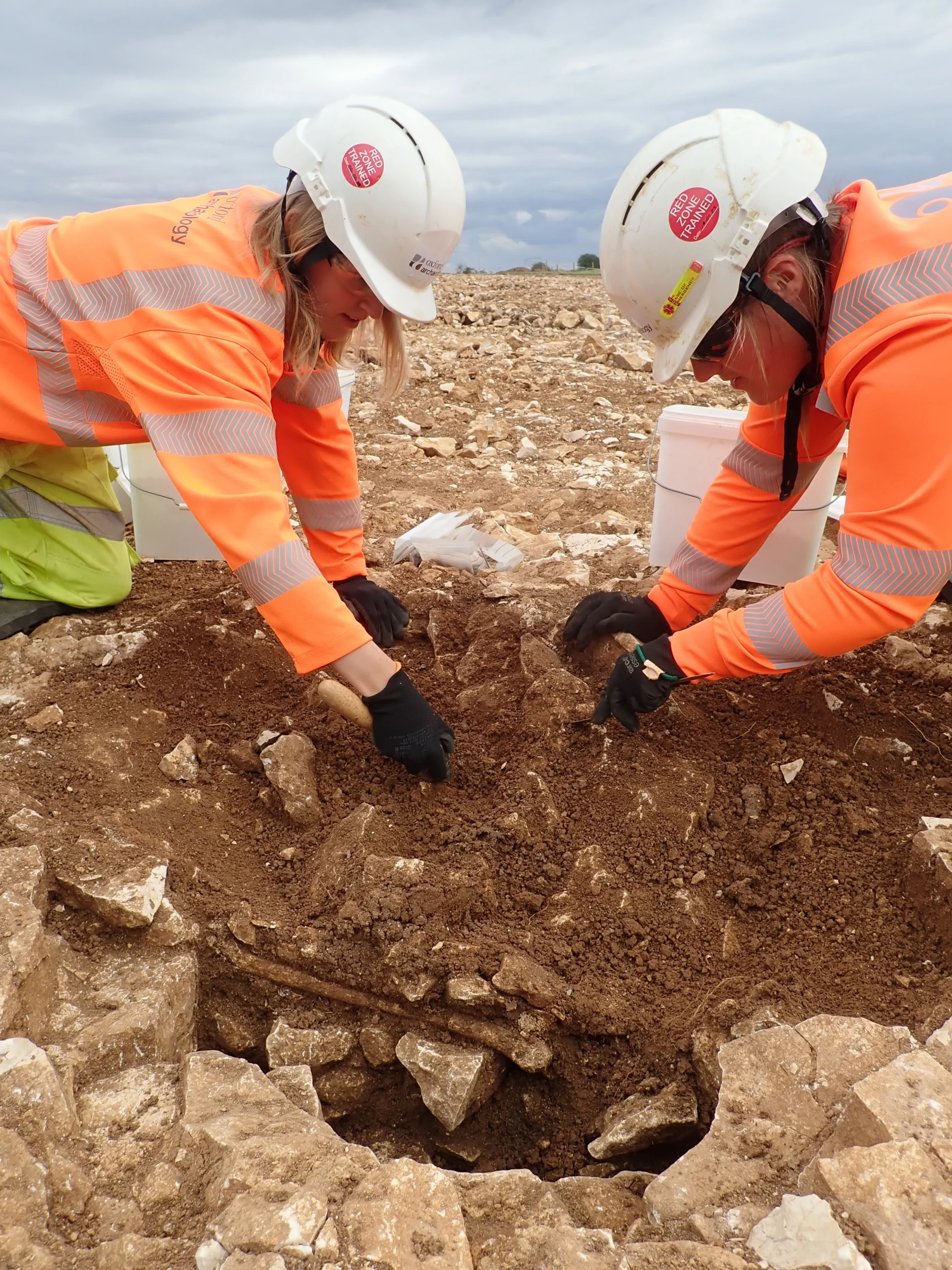 Area 12 grace being excavated by two archaeologists