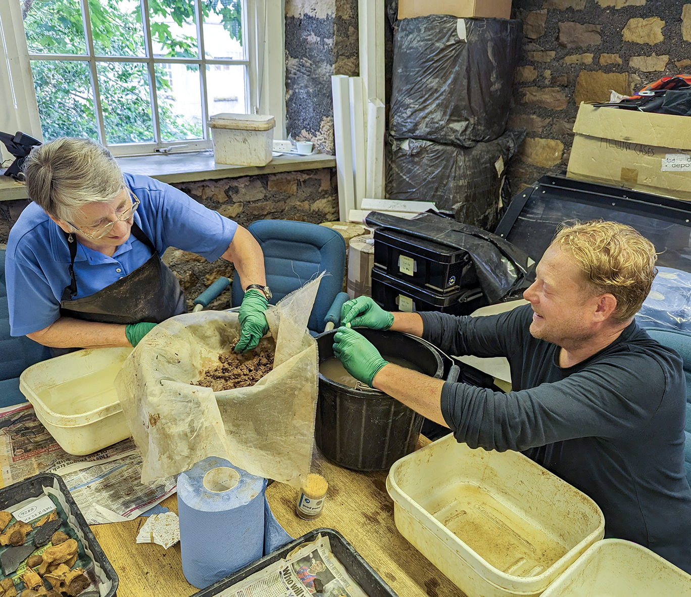 Two volunteers wash finds