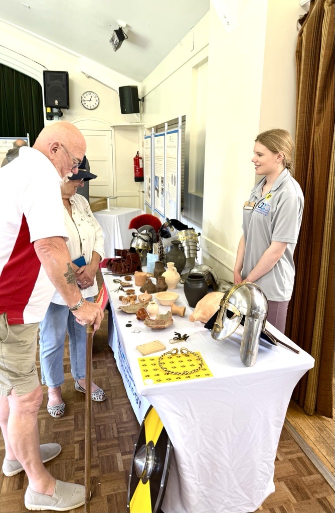 OCA staff member showing visitors replicas and local handling finds