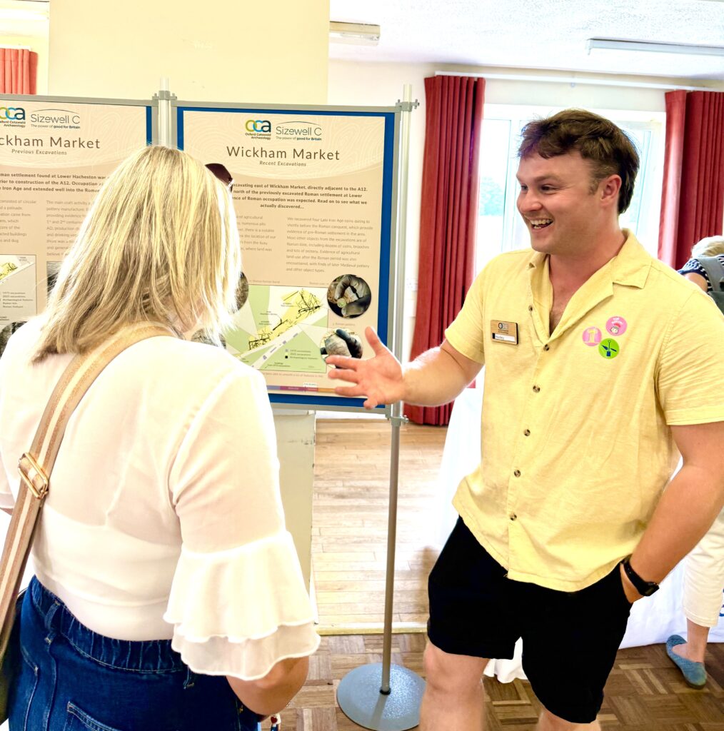 Photo of an OCA staff member speaking enthusiastically with a visiting member of the public