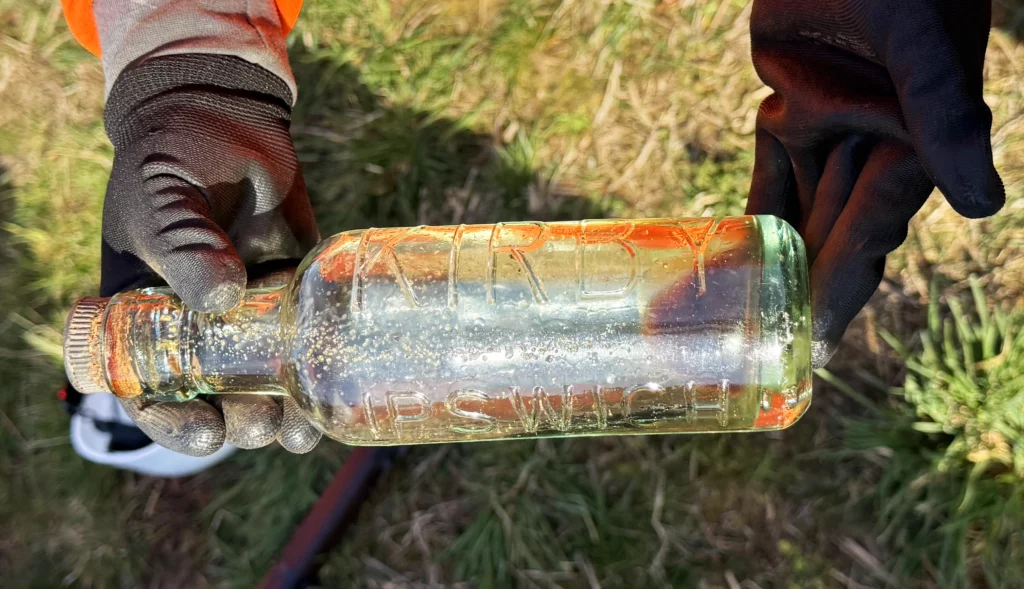 Image of a glass Kirby's of Ipswich bottle being held and displayed.