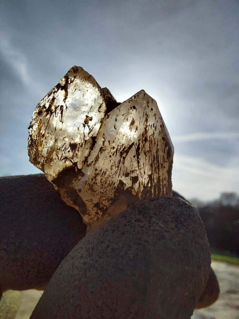 Archaeologist holding transparent rock crystal