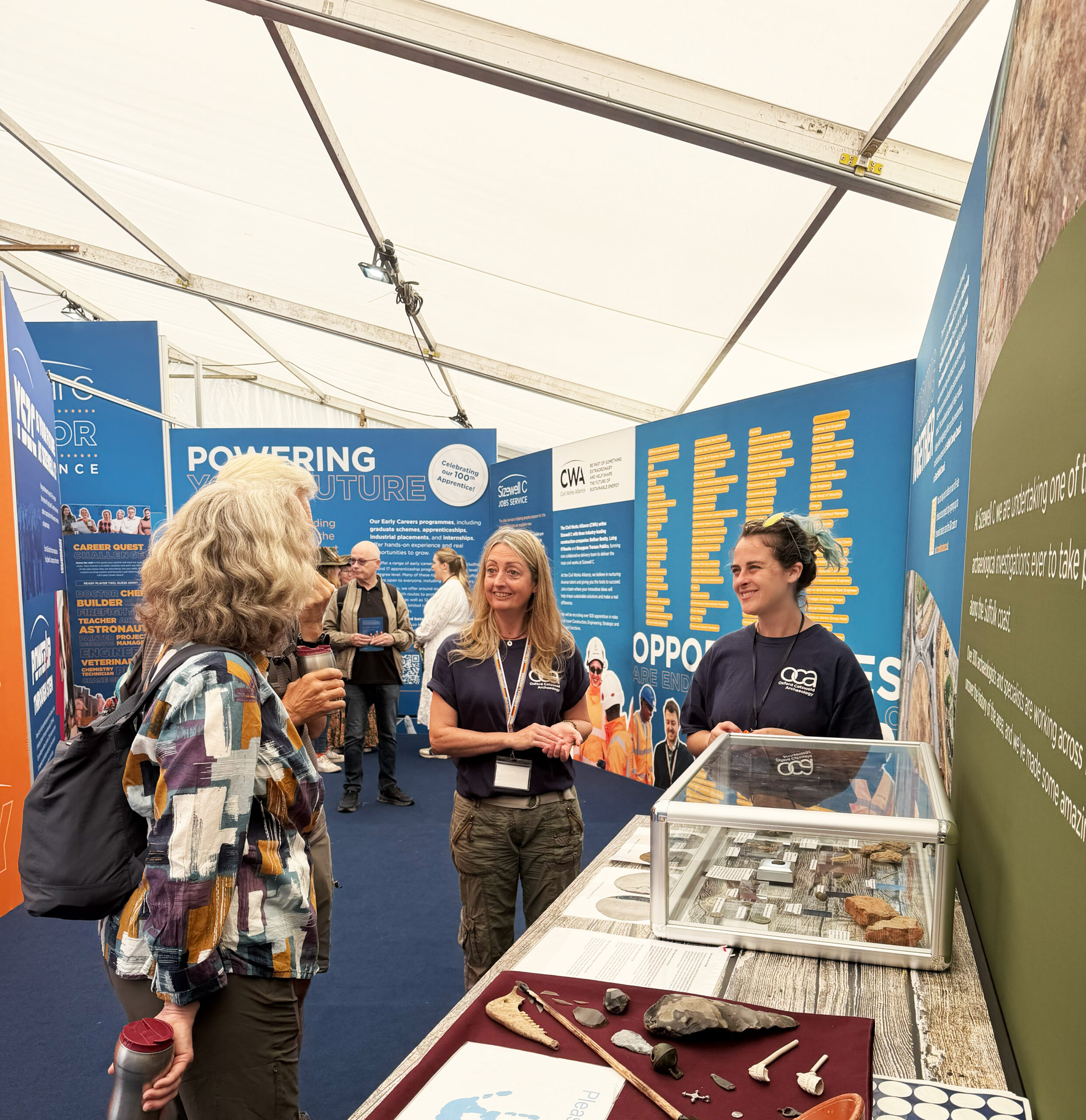 OCA staff members talking to members of the public about archaeological artefacts in the sizewell marquee at the suffolk show