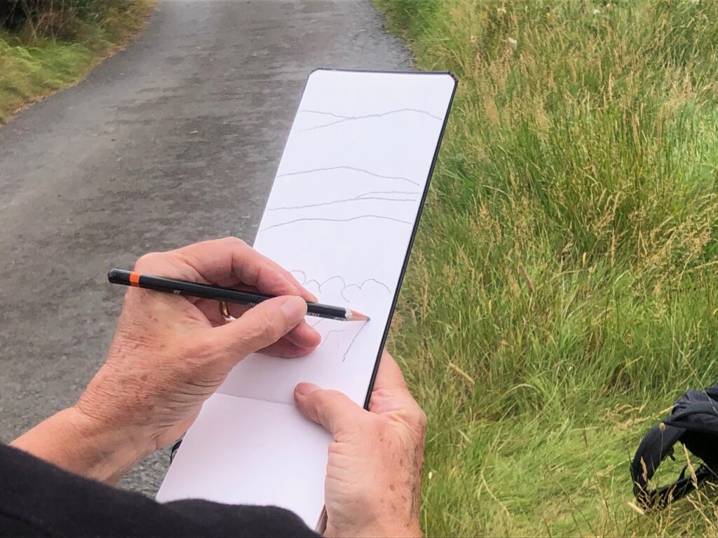 Participant sketching landscape on sketch walk